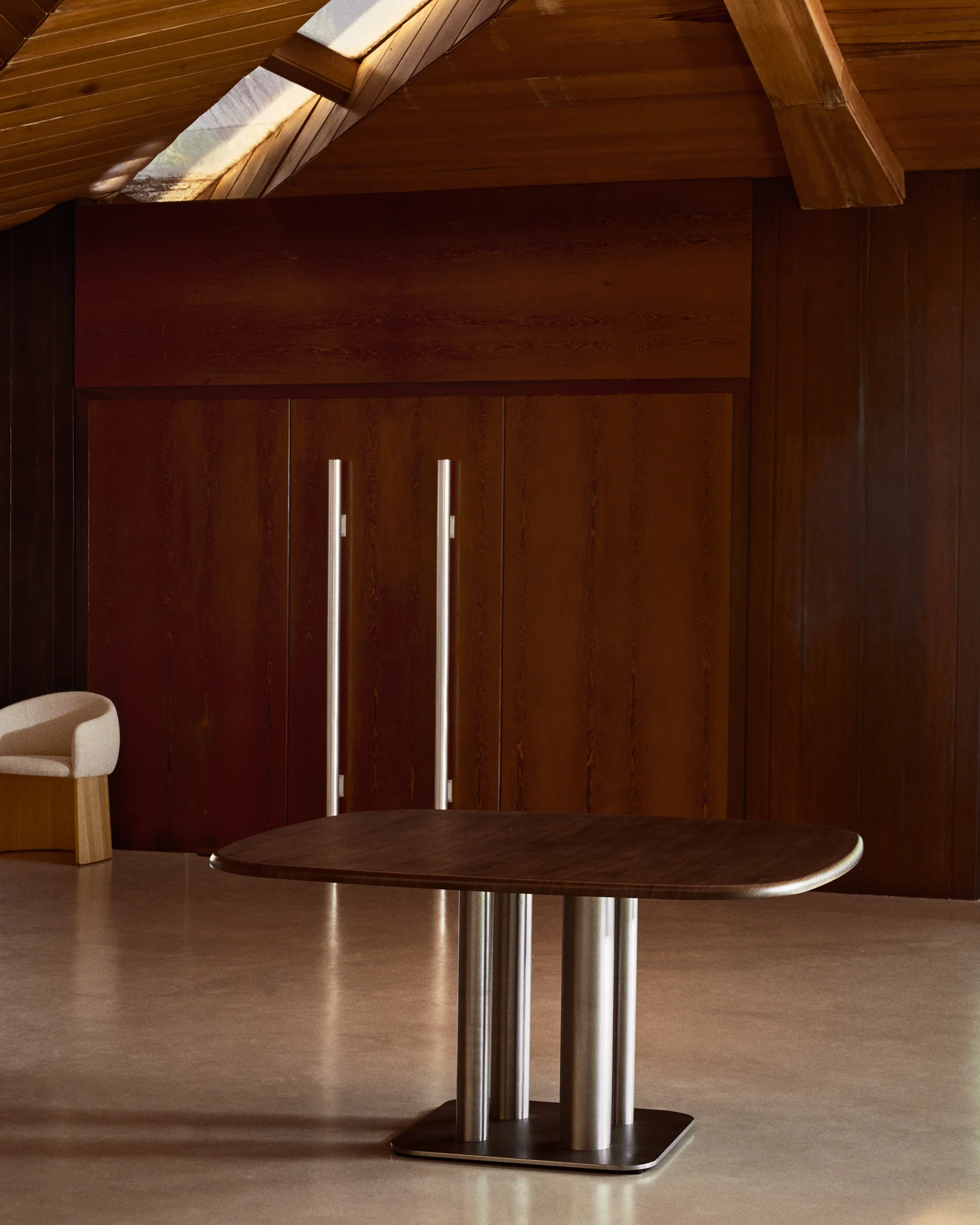 Melvar table made from walnut veneer and legs with brushed stainless steel base 150 x 150cm