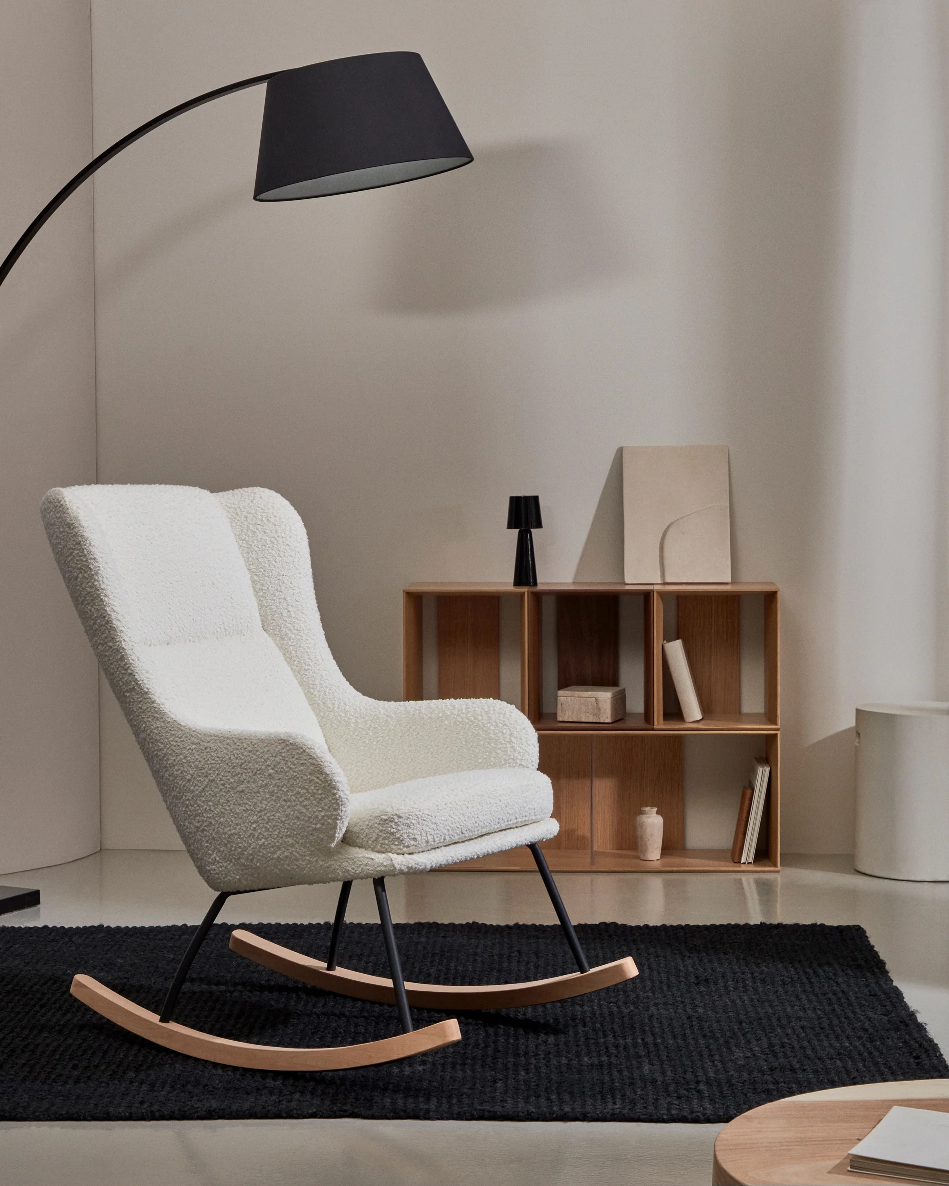 Maustin rocking chair in white bouclé with a black steel structure and beech wood