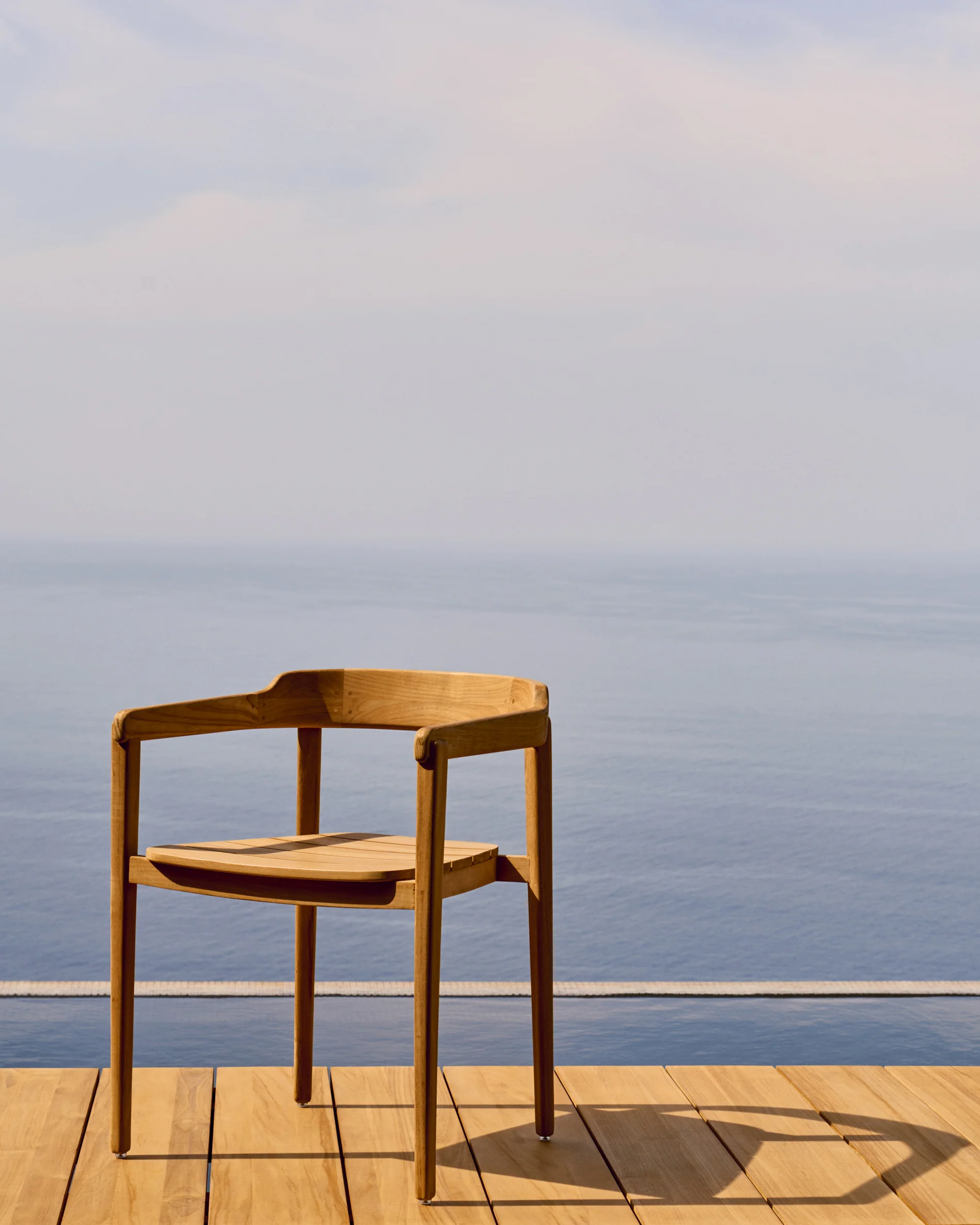 Icaro stackable solid teak wood chair in a natural finish, FSC 100%