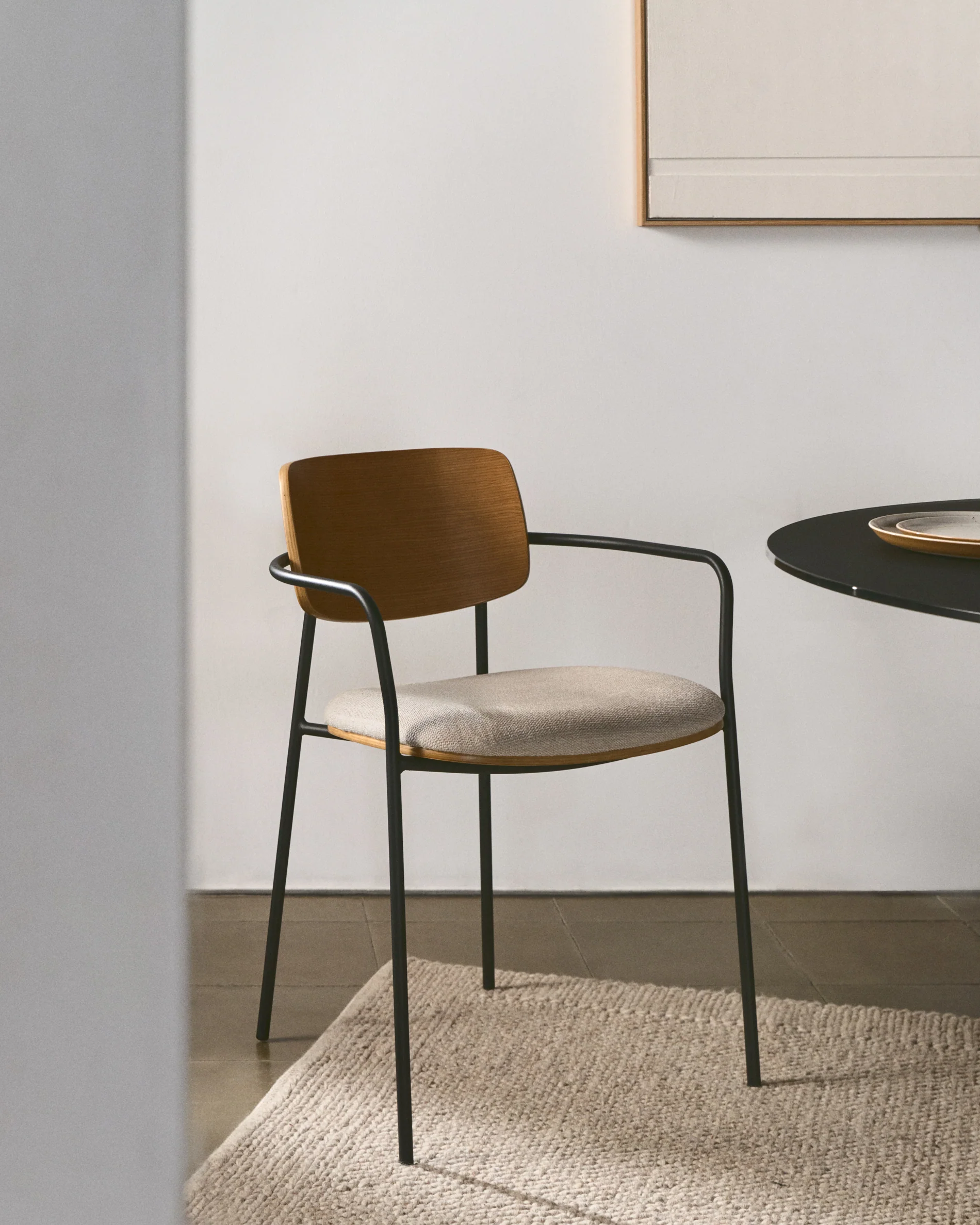 Maureen stackable chair in poplar plywood with light tone finish and black metal legs, 100% FSC.