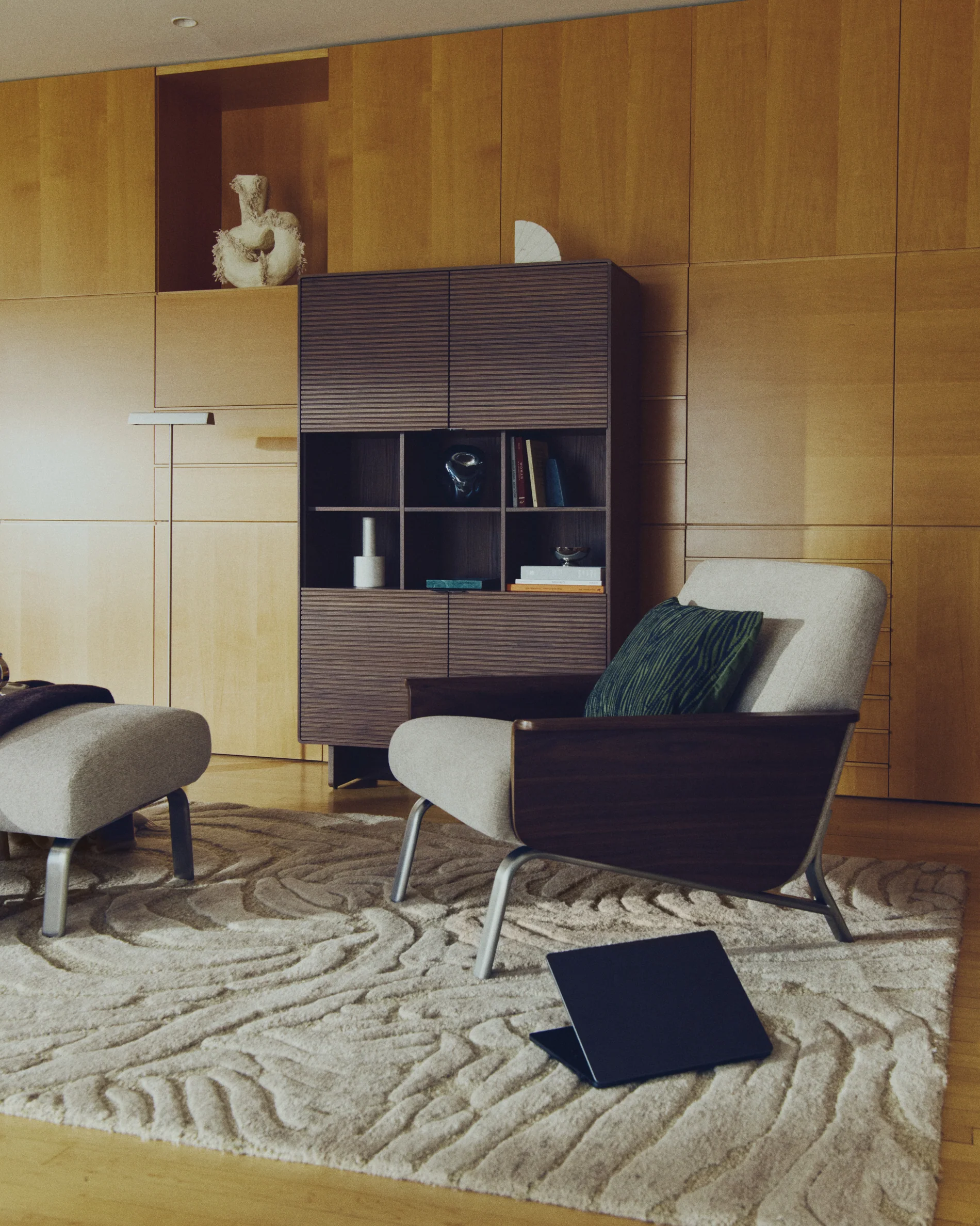 Amsen light brown armchair in walnut plywood with legs in brushed stainless steel