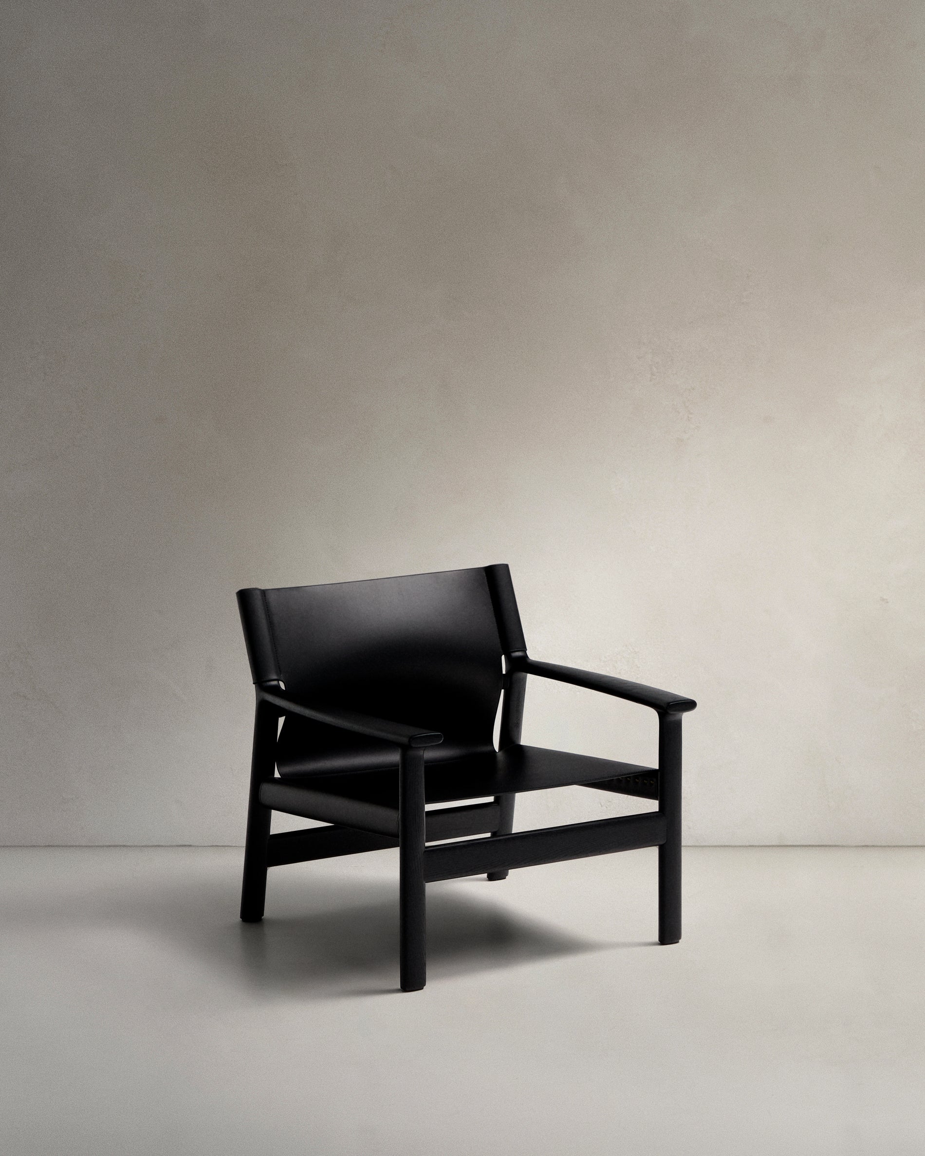 Jan armchair made of black recycled leather fibres and FSC 100% solid ash wood with black finish